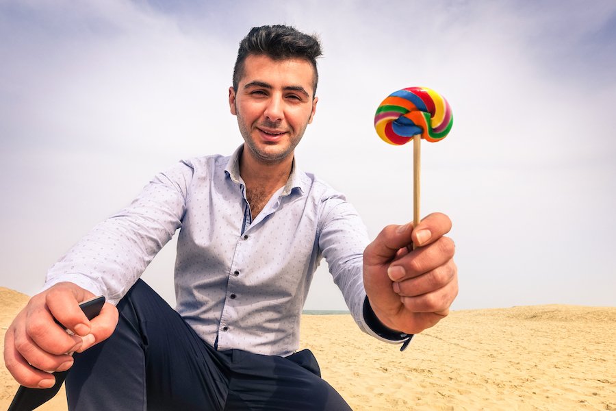 Adult luring a child with a lollipop