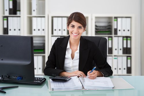 smiling female accountant at a desk