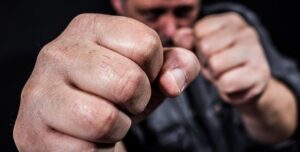 Man committing assault by holding up fists and trying to punch