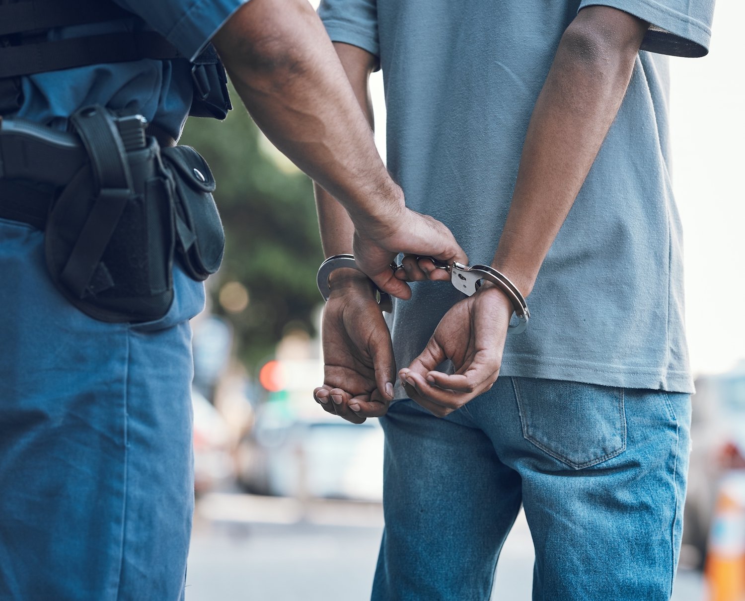 Police handcuffing a suspect on a city street