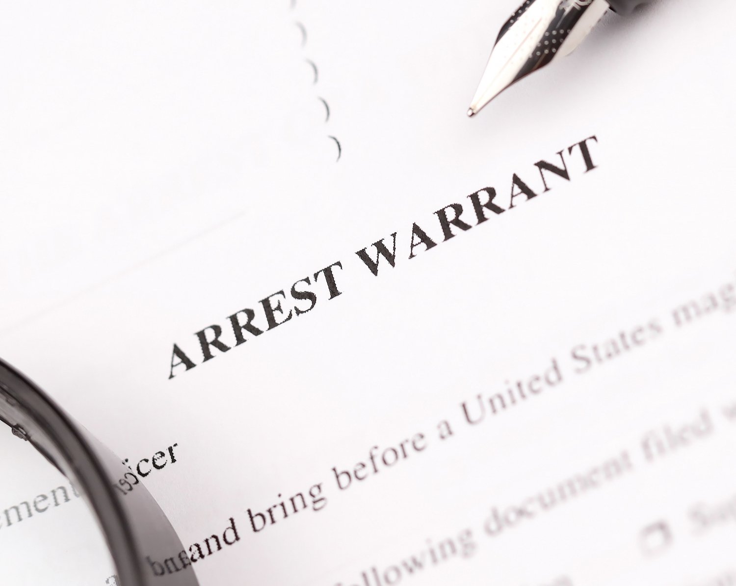 An arrest warrant application and affidavit on white pleading paper