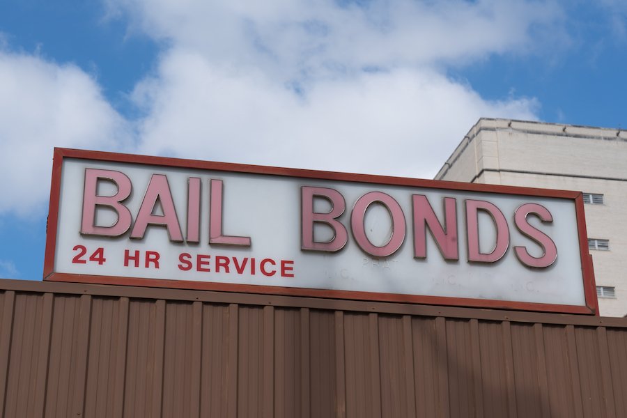 Storefront of bail bonds company against a blue sky