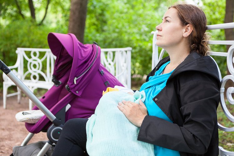 Mother breastfeeding in a public park