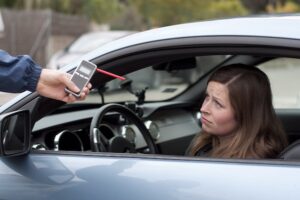 DUI suspect being given a breath test after being pulled over