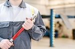 Car mechanic holding a tool
