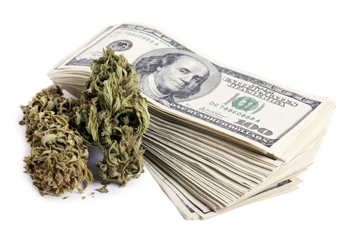 Marijuana and stack of $100 bills - Unauthorized sale of marijuana is a crime in Nevada.