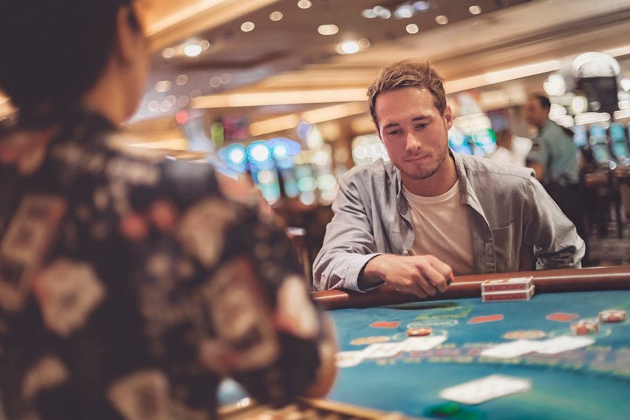 Forlorn man gambling over a casino table