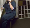 Inmate holding phone in jail
