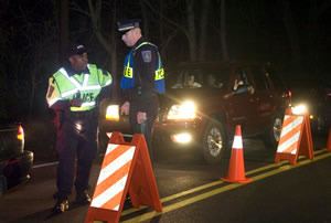 DUI checkpoint officers putting out proper signage. 