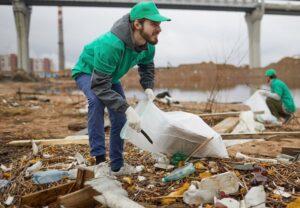 Man picking up trash by highway