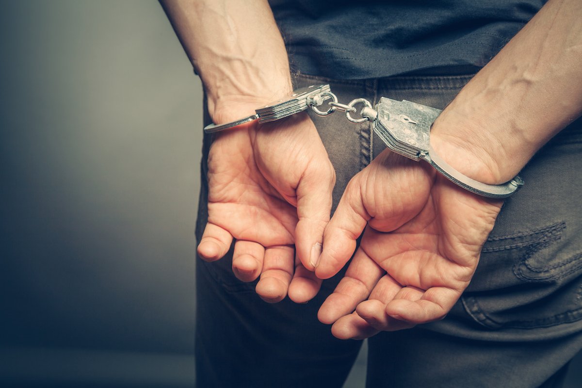 Closeup of man's hands in handcuffs following an arrest