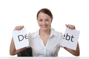 Woman holding up debt sign that she tore in half