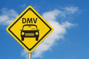 DMV sign against blue sky