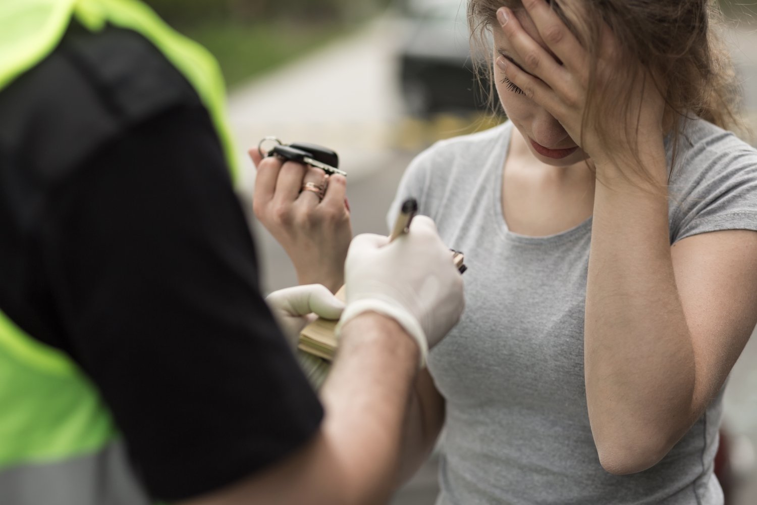 Distressed woman speaking with police during DUI stop