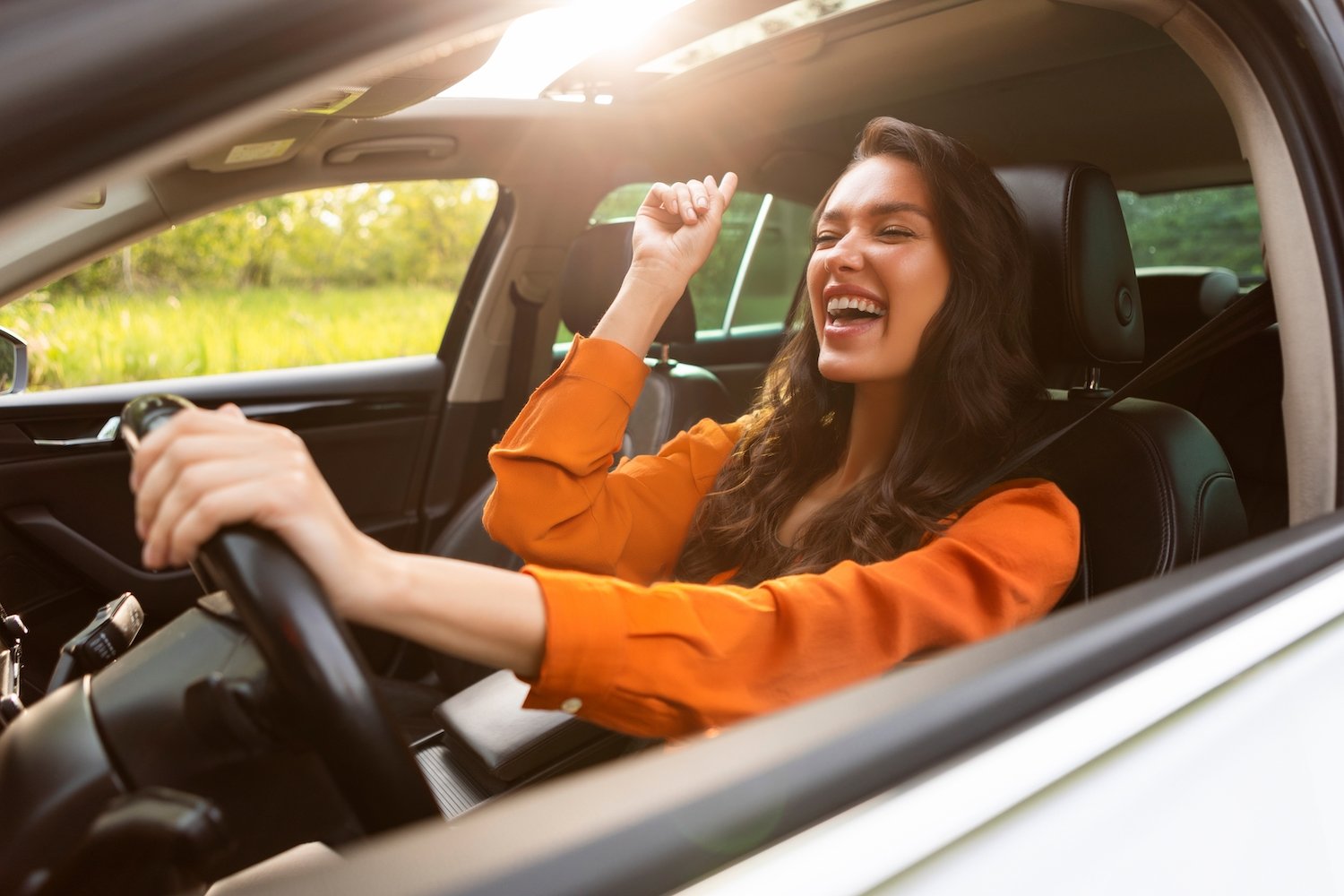Drunk young woman behind the wheel of a car