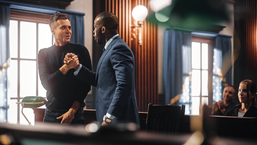 Attorney congratulating client after victory in court