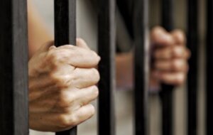 Hands on jail bars
