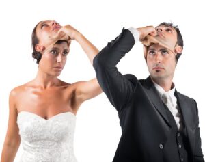 Bride and groom wearing masks of other people