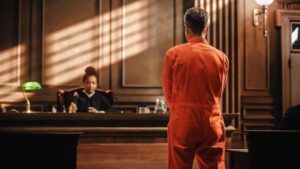 Defendant in orange jumpsuit in court