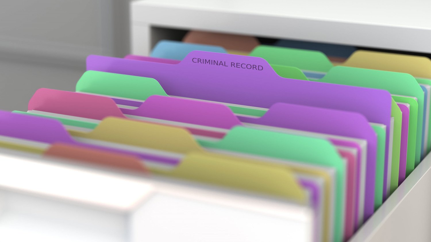 Filing cabinet with an open drawer with multi-color file folders labeled "criminal record"