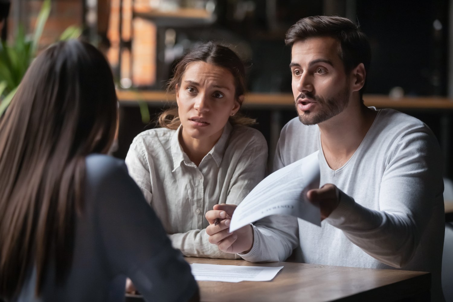 A couple quarreling with an insurance agent about their application