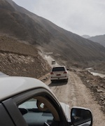 Two cars driving on a road.