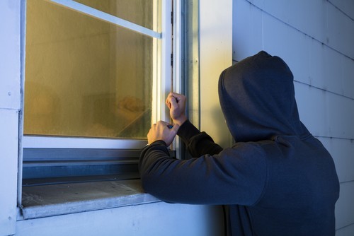 Hooded man opening a window to commit home invasion in Nevada