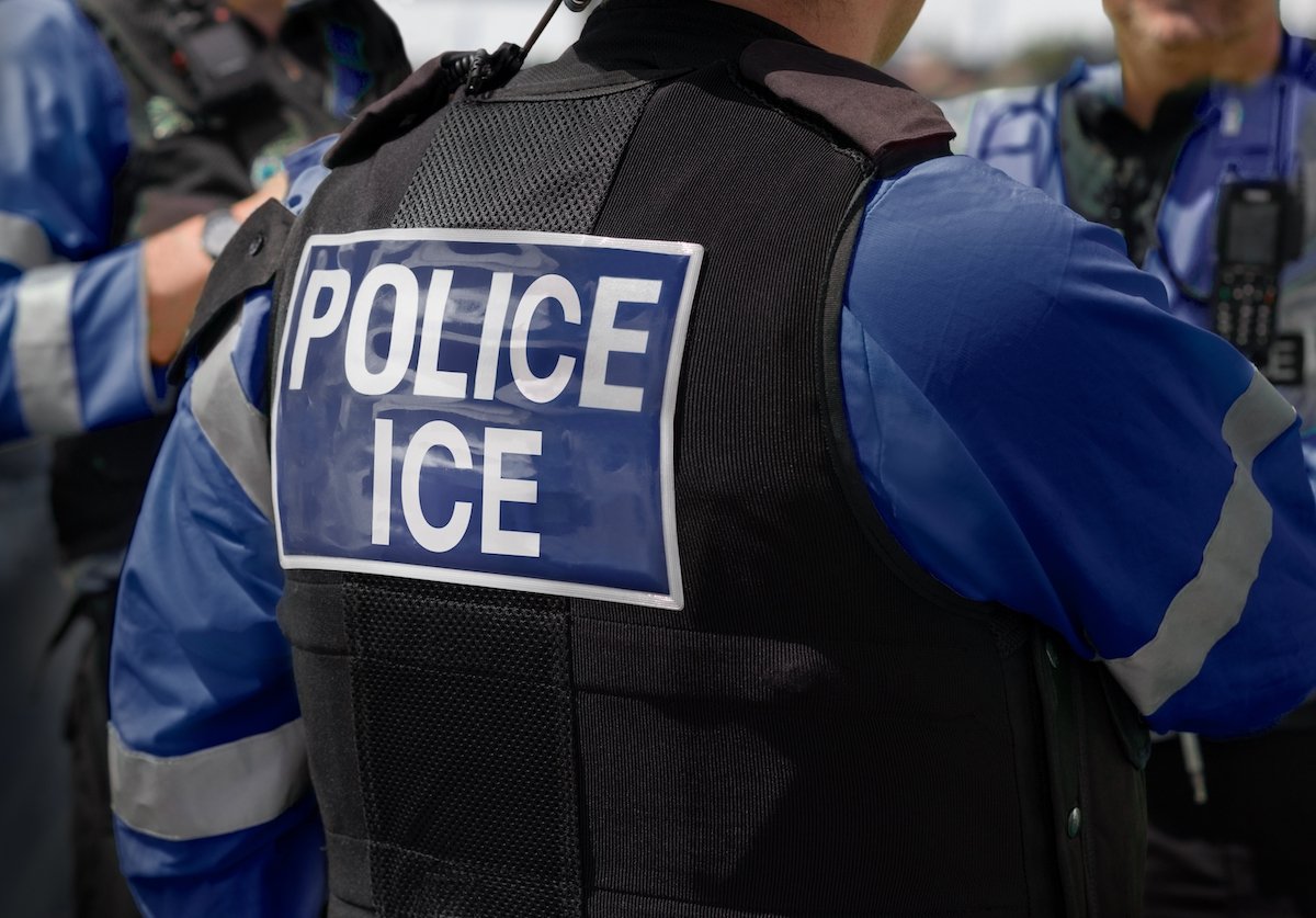 ICE agent about to execute an arrest on an undocumented person
