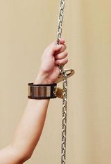 woman's arm cuffed to a chain
