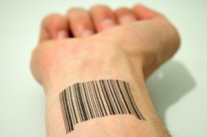 Wrist with barcode tattooed on it