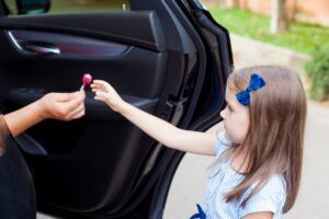 Stranger's hand giving lollipop to child before stranger kidnaps the child in violation of NRS 200.310