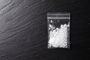 Bag holding meth against black table