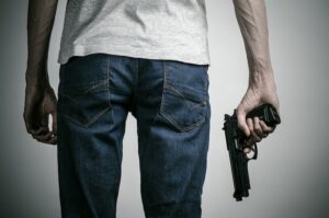 Man holding a gun in right hand