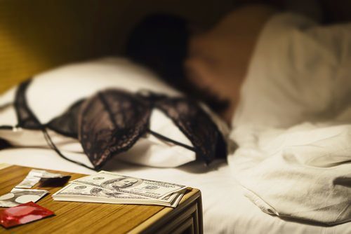 cash on bedstand following an act of prostitution
