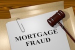 "mortgage fraud" text on a piece of paper beneath a judge's gavel