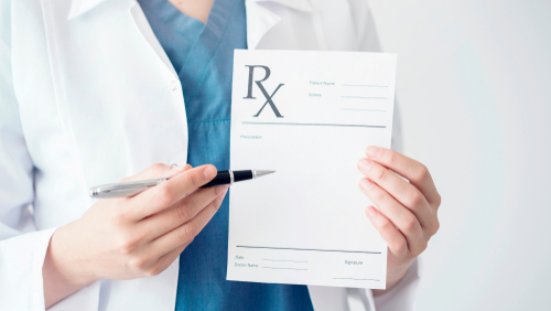 nurse holding up RX pad 