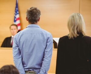 Judge in courtroom sentencing defendant standing next to his attorney to probation in accordance with NRS 176A.500