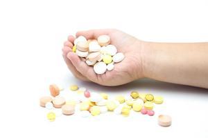 Hand overflowing with pills; imitation drugs are illegal in Nevada under NRS 453.332 