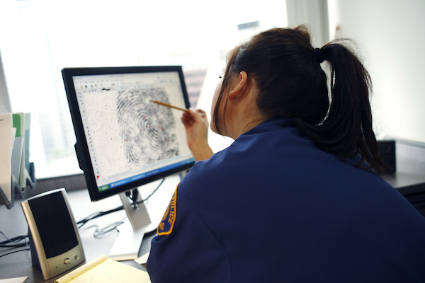 Police officer studying fingerprints during a pre-file investigation in Nevada