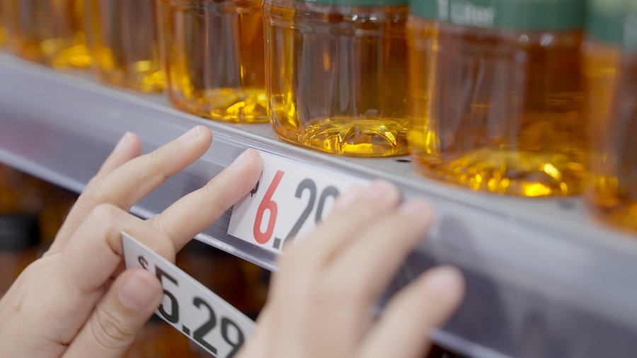 Closeup of hands switching prices in grocery store