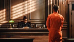 Probationer in orange jumpsuit before judge during a probation violation hearing