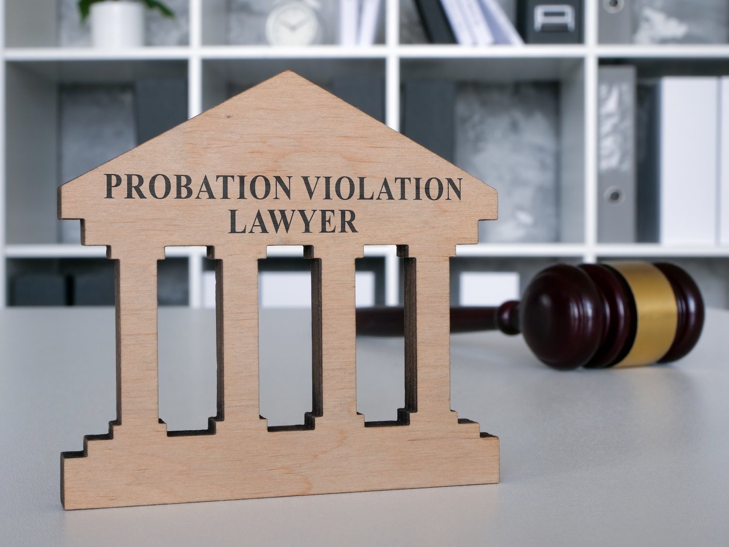 Sign that says "probation violation lawyer" next to a gavel on a desk