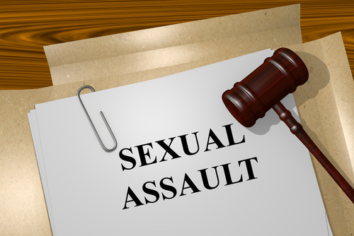 Graphic that shows a judge's gavel over white paper that says "sexual assault"