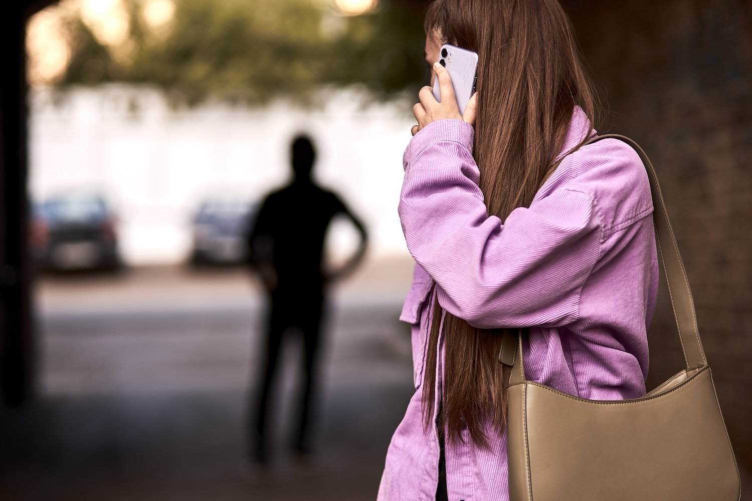 Woman looking behind her at a stalker following her in violation of a restraining order in Nevada