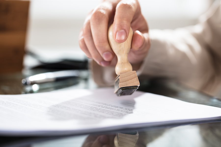 Judge's hand rubber-stamping petition to seal