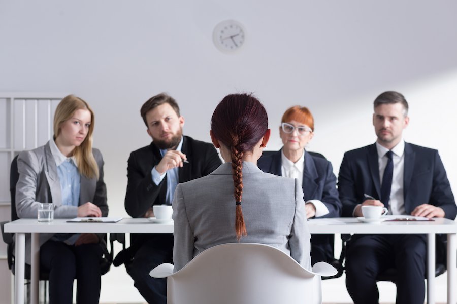 Job applicant during job interview and four interviewers