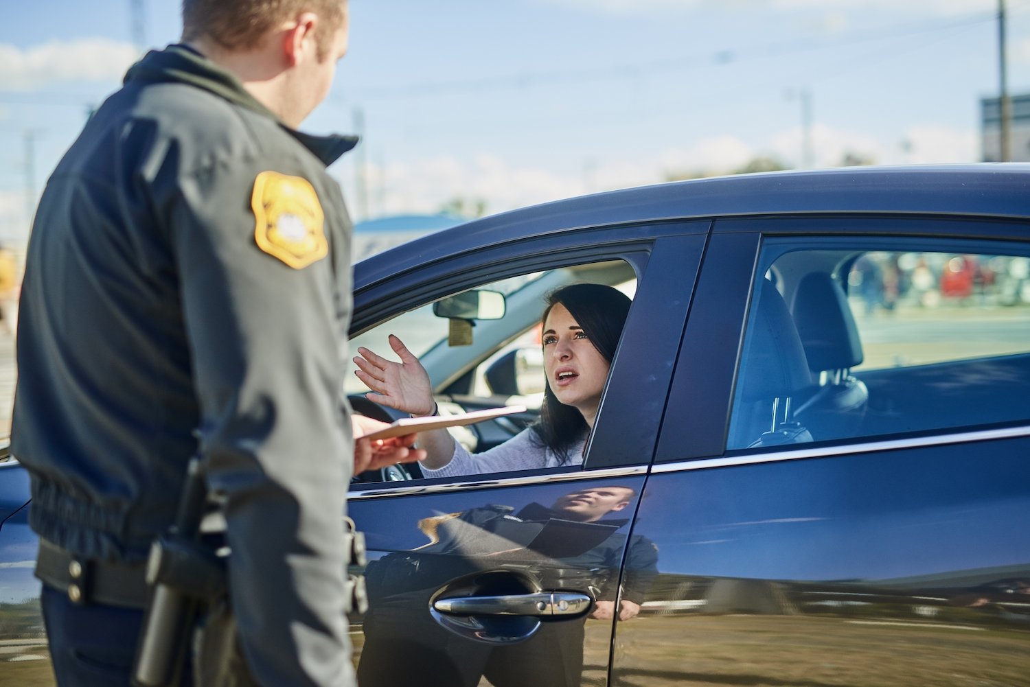 Police questioning driver during traffic stop on the road
