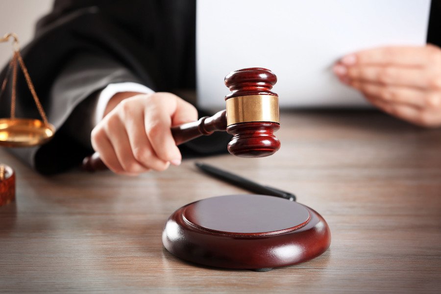 Judge hammering gavel down at bench during a court hearing