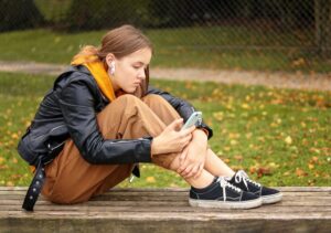Outside shot of a young girl on phone with sexual predator planning to commit lewdness with the girl