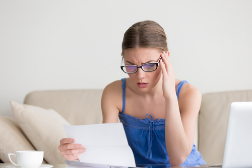troubled woman looking at letter